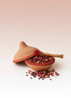 Aker Fassi natural Moroccan lip and cheek tint made with poppy petals and pomegranate peel in traditional terracotta vessel.